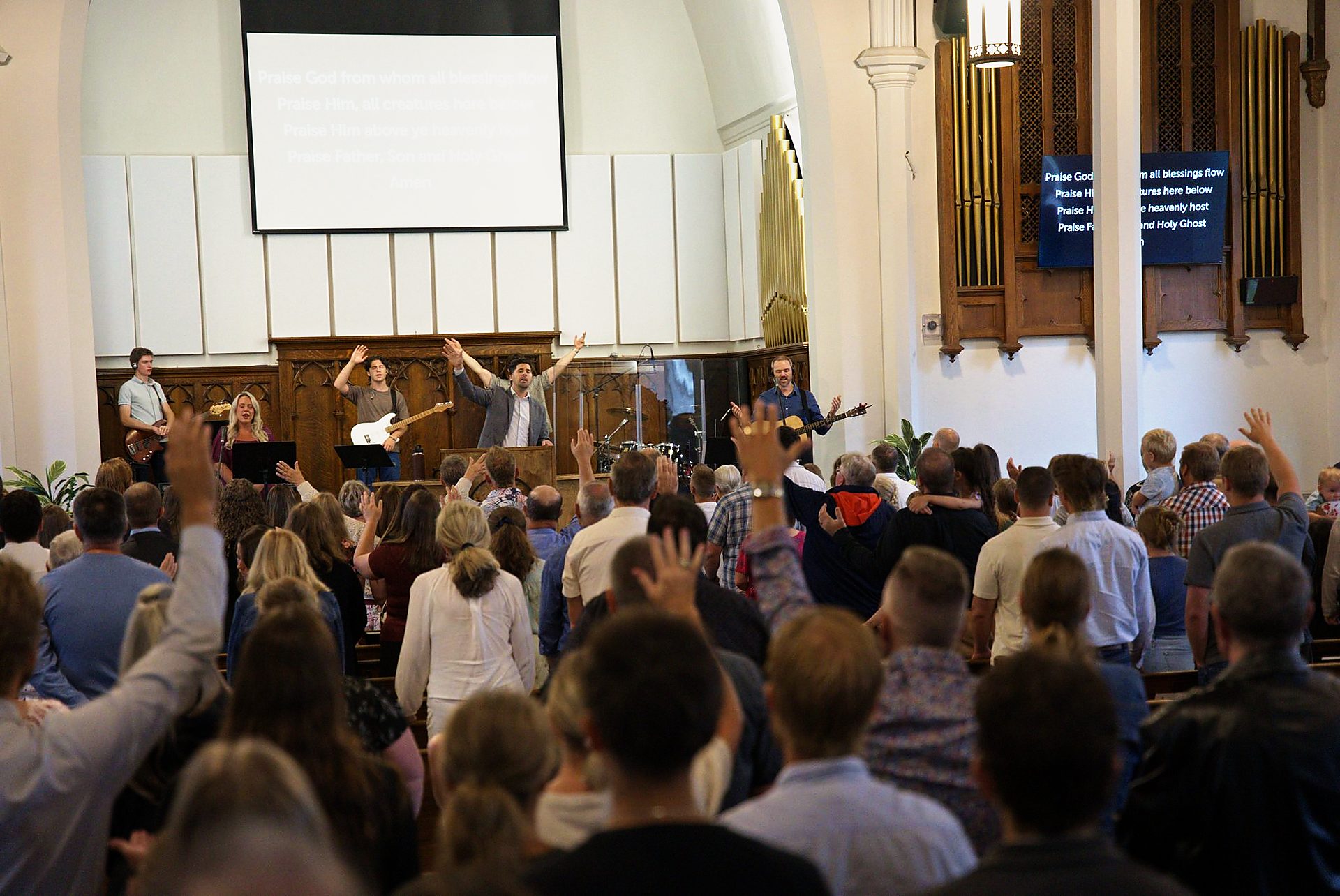 The congregation singing together on a Sunday morning